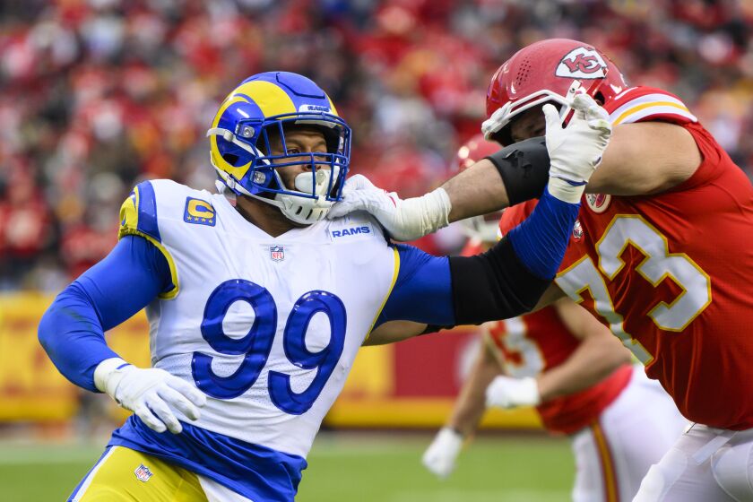 Los Angeles Rams defensive tackle Aaron Donald (99) battles Kansas City Chiefs guard Nick Allegretti (73) during the first half of an NFL football game, Sunday, Nov. 27, 2022 in Kansas City, Mo. (AP Photo/Reed Hoffmann)