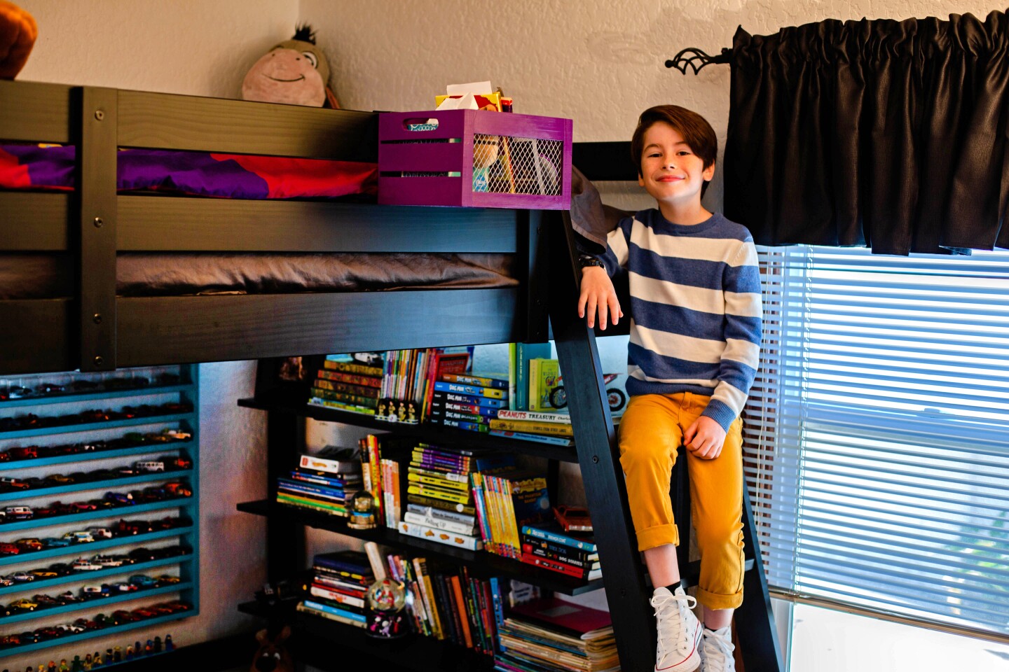 VENTURA, CALIF. - SEPT. 6, 2019 - Actor Paxton Booth plays Ollie Wrather on the Disney Channel series, "Coop & Cami Ask The World." Paxton’s bedroom, in his parents’ Ventura home, houses all the things he loves - vinyl LPs he finds at swap meets, lanyards from the red-carpet events he attends, his Mickey Mouse ears and a series of newsboy caps. The bedroom features a mash-up of colors - a red dresser, a fuchsia rug, purple bedding. (Jesse Goddard / For The Times)