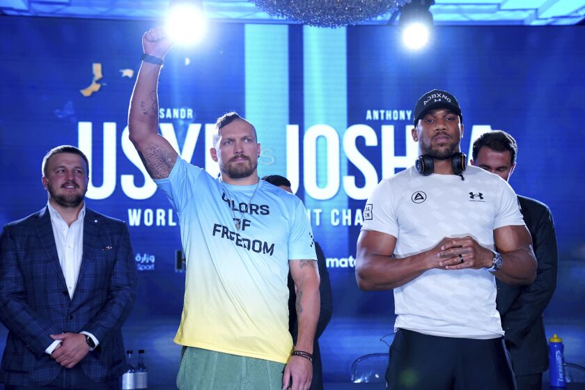 Boxers Oleksandr Usyk, left, and Anthony Joshua pose during a press conference, Wednesday June 29, 2022, in London. (Nick Potts/PA via AP)