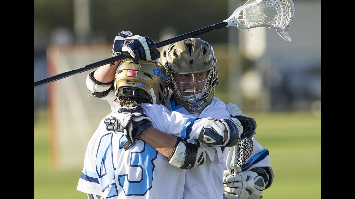 Cornoa del Mar's Eric Fries, left, hugs Landon Whitney after he scored a goal against Servite in the quarterfinals of the U.S. Lacrosse Southern Section South Division playoffs on Thursdasy, May 4.