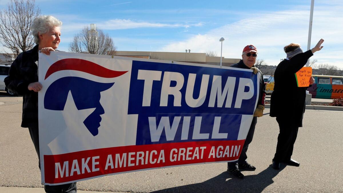 Supporters of President Trump's orders on immigration and refugees rally outside the Farmington Museum at Gateway Park in Farmington, N.M. (Hannah Grover / Associated Press)