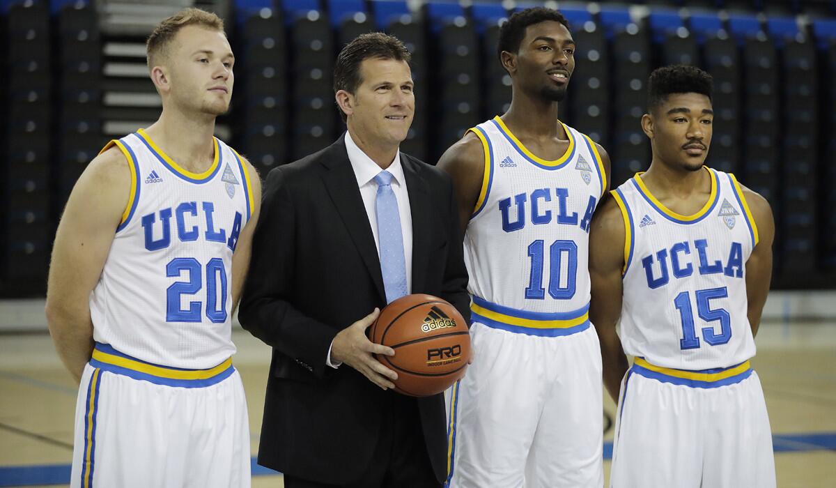 UCLA's Bryce Alford, Coach Steve Alford, Isaac Hamilton and Jerrold Smith, from left, pose for photos during the team's media availability on Oct. 12.