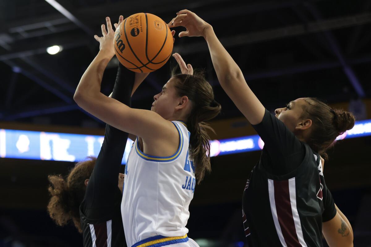 UCLA's Gabriela Jaquez shoots in front of Bellarmine's Cam Browning, left, and Paetynn Gray.