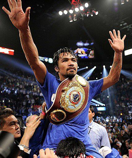 Manny Pacquiao is given a victory ride by his cornermen after defeating Shane Mosley by unanimous decision on Saturday night at the MGM Grand Garden Arena in Las Vegas.