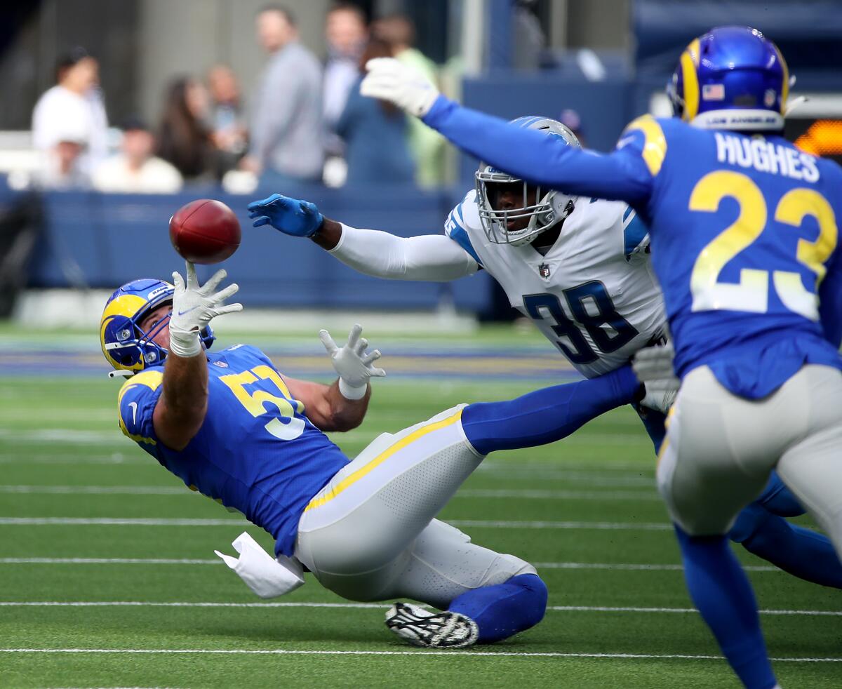 Rams linebacker Tony Reeder tries to grab an onside kick before Lions safety C.J. Moore in the first quarter.