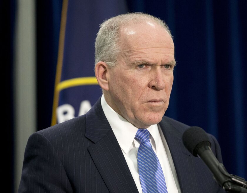 CIA Director John Brennan listens during a news conference at the agency's headquarters in Langley, Va.