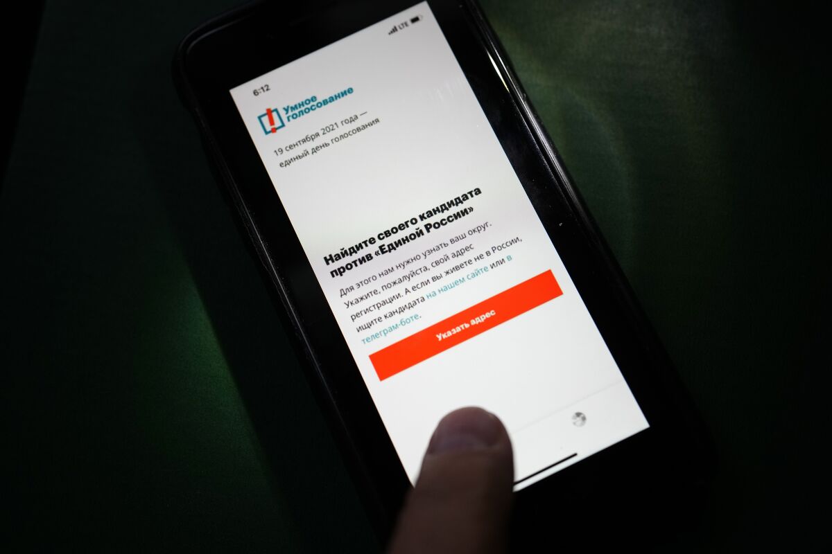 The app Smart Voting is displayed on an iPhone screen in Moscow, Russia, Friday, Sept. 17, 2021. Facing Kremlin pressure, Apple and Google on Friday removed from their online stores an opposition-created smartphone app that tells voters which candidates are likely to defeat those backed by Russian authorities, as polls opened in Russia's parliamentary election. (AP Photo/Alexander Zemlianichenko)