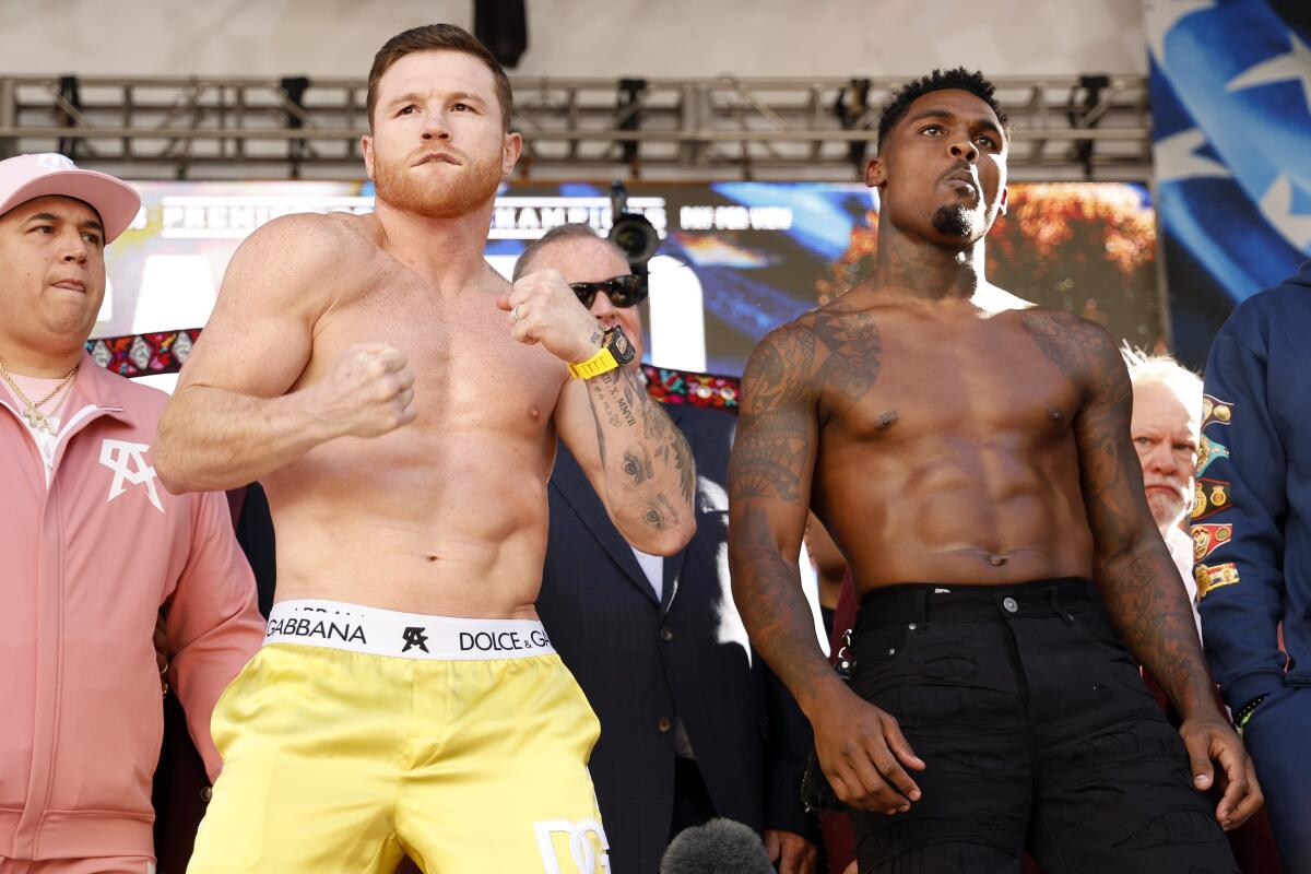 Undisputed super middleweight champion Saul “Canelo” Alvarez and Jermell Charlo pose side-by-side at a weigh-in
