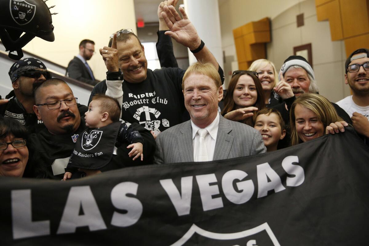 Oakland Raiders owner Mark Davis, center, meets with Raiders fans after speaking at a meeting of the Southern Nevada Tourism Infrastructure Committee in Las Vegas.