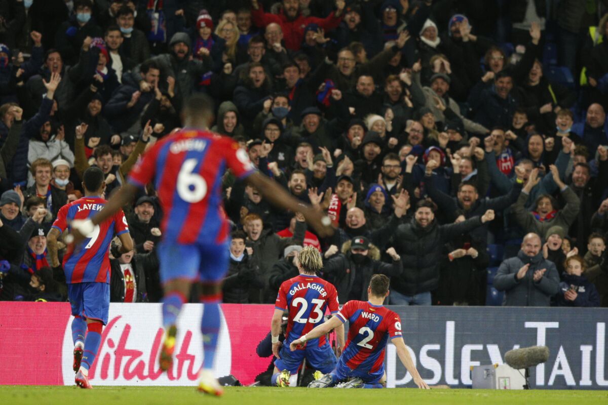 Crystal Palace's Conor Gallagher, centre, celebrates after scoring his side's third goal during an English Premier League soccer match between Crystal Palace and Everton at Selhurst Park, London, Sunday Dec. 12, 2021. (AP Photo/David Cliff)