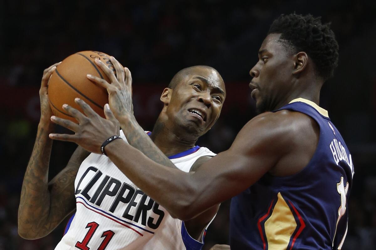 Clippers guard Jamal Crawford struggles to get to the basket against Pelicans defender Jrue Holiday in the first half