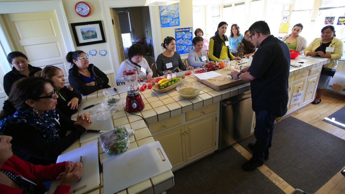 Miguel Valdez, executive chef from Red Door and Wellington Steak & Martini Lounge in San Diego, teaches a class as part of the Cooking for Salud seven-week bilingual course at Olivewood Gardens and Learning Center in National City in March 2016.
