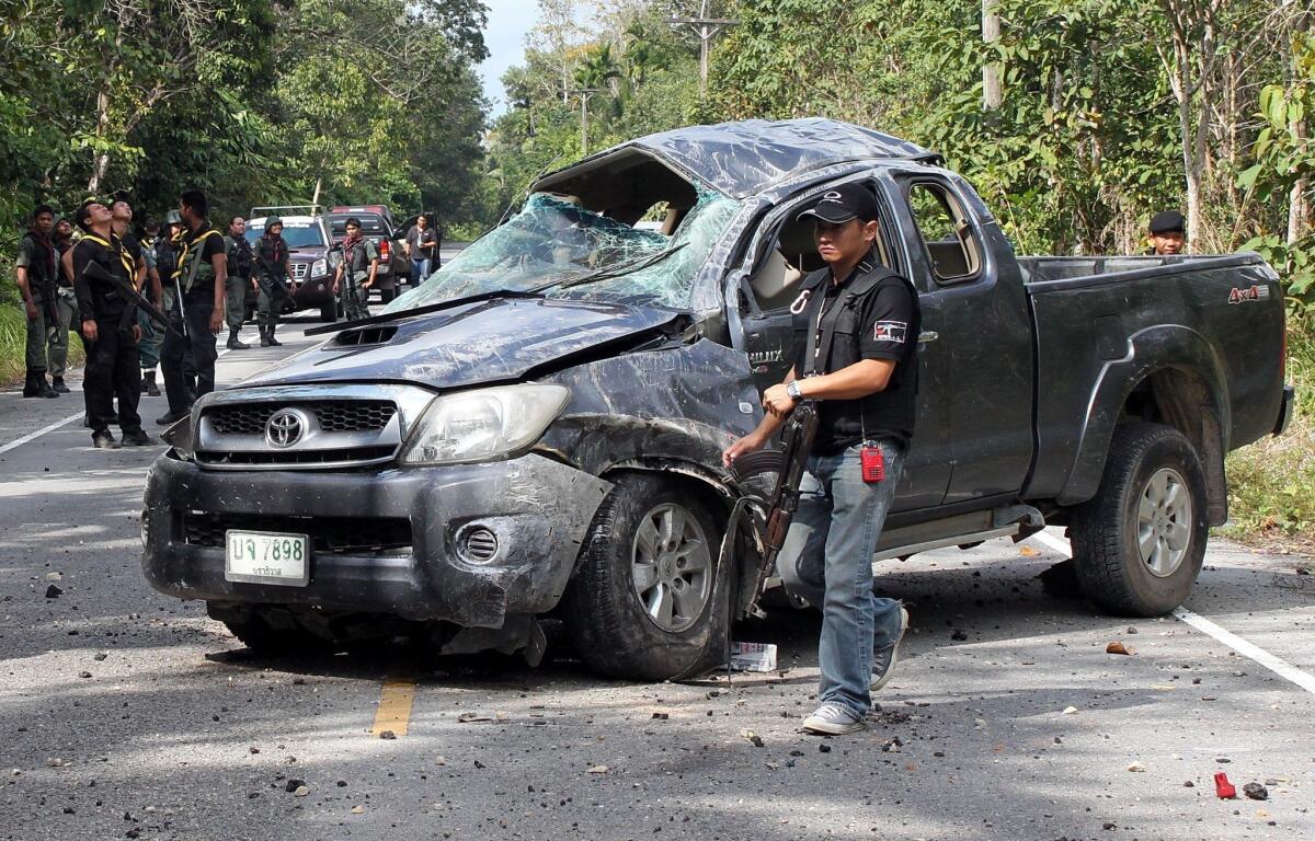 Thai police inspect the site of a bombing by suspected separatist militants in Thailand's southern province of Narathiwat on Feb. 10. The roadside bomb struck a pickup truck carrying army rangers, killing five soldiers, police said.