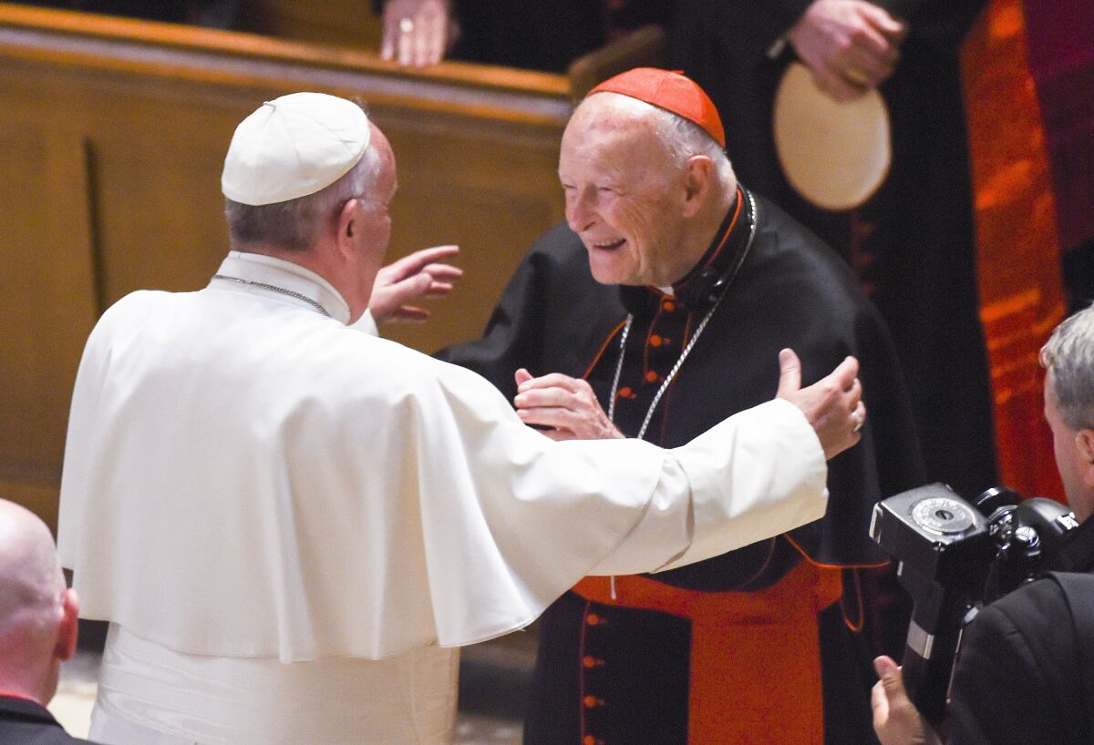 Pope Francis reaches out to hug Cardinal Archbishop Emeritus Theodore McCarrick in Washington in September 2015.
