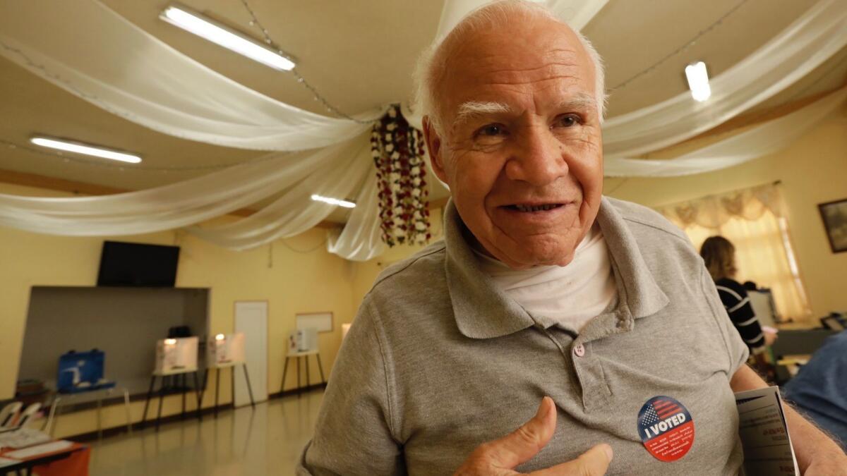 Roberto Rodriguez shows off his "I Voted" sticker after casting his ballot Tuesday at First Mexican Baptist Church in East Los Angeles.