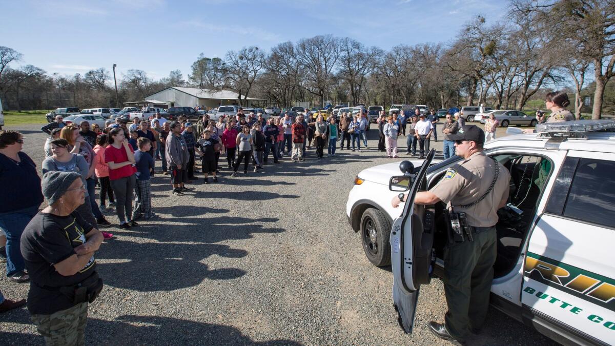 Evacuees at the Bangor Community Hall learn from sheriff's deputies that they can return home Tuesday.