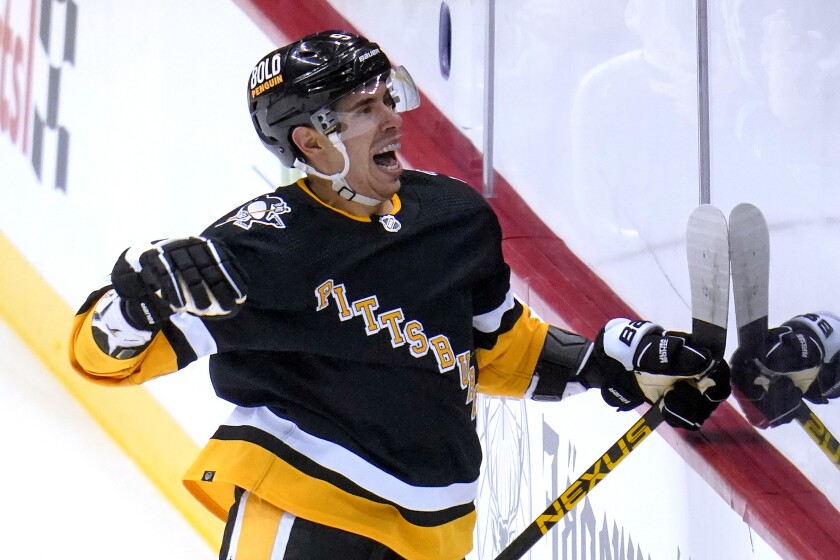 Pittsburgh Penguins' Evan Rodrigues (9) celebrates his first of two goals in the first period during an NHL hockey game against the San Jose Sharks in Pittsburgh, Sunday, Jan. 2, 2022. (AP Photo/Gene J. Puskar)
