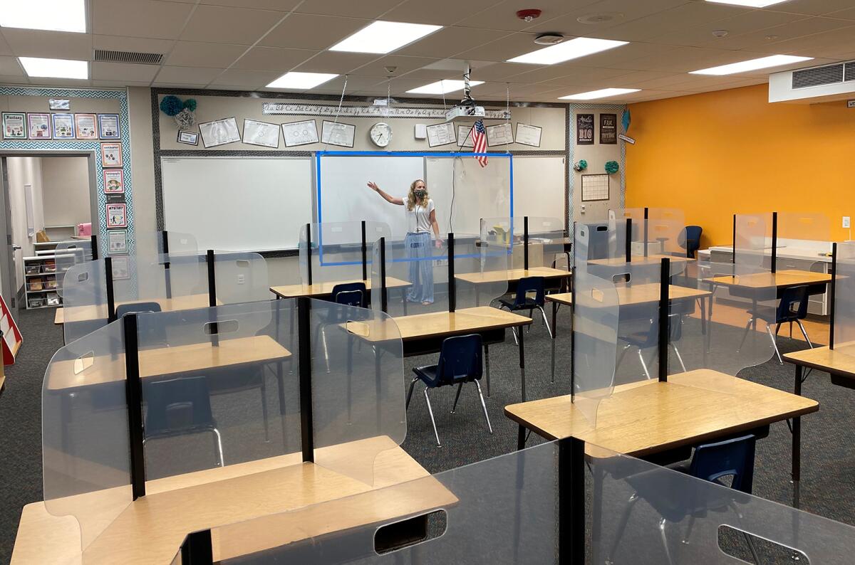 Ocean View School District Supt. Carol Hansen in a classroom with protective plastic shields.