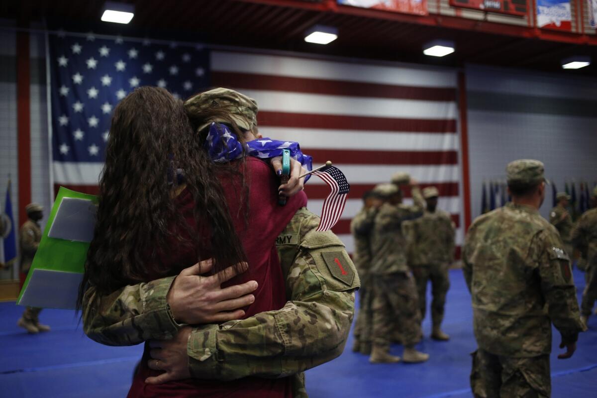 Soldiers are reunited with family members at Ft. Knox in Kentucky earlier this year. A new study calls military caregivers "hidden heroes," and calls to give them more support.