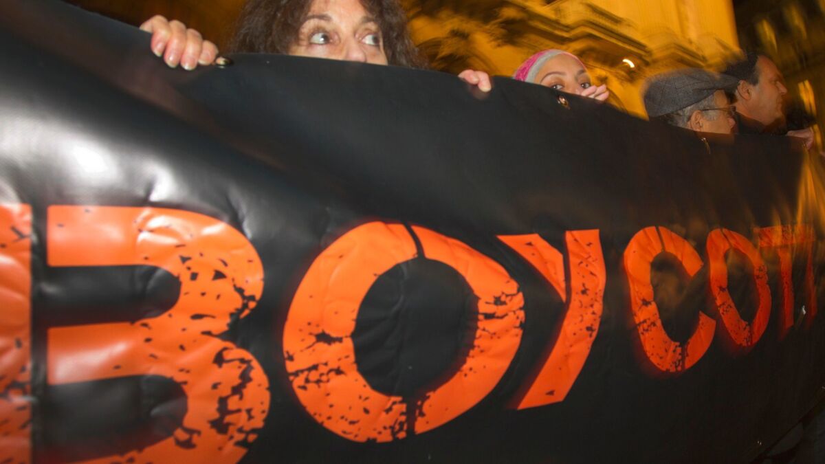 French demonstrators and supporters of Palestinians hold a placard with the word "Boycott" during a 2012 demonstration in Paris.