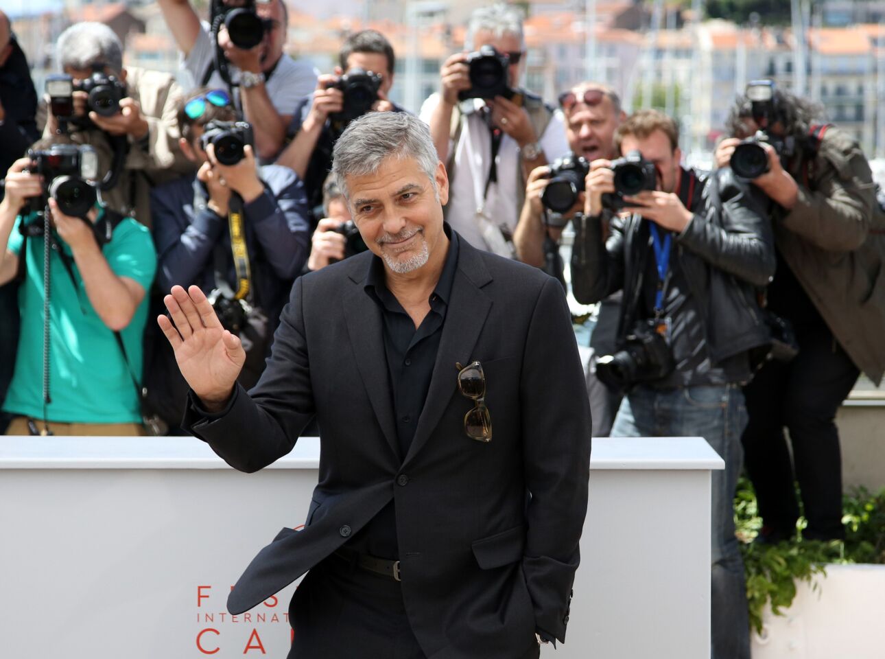 George Clooney of "Money Monster" waves to photographers at the Cannes Film Festival.
