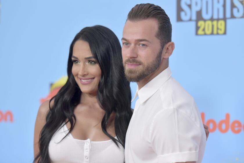 Nikki Bella, left, and Artem Chigvintsev arrive at the Kids' Choice Sports Awards on Thursday, July 11, 2019, at the Barker Hangar in Santa Monica, Calif. (Photo by Richard Shotwell/Invision/AP)