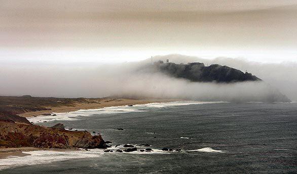 Fog and wildfire smoke form a ring around Point Sur Lighthouse in Big Sur.