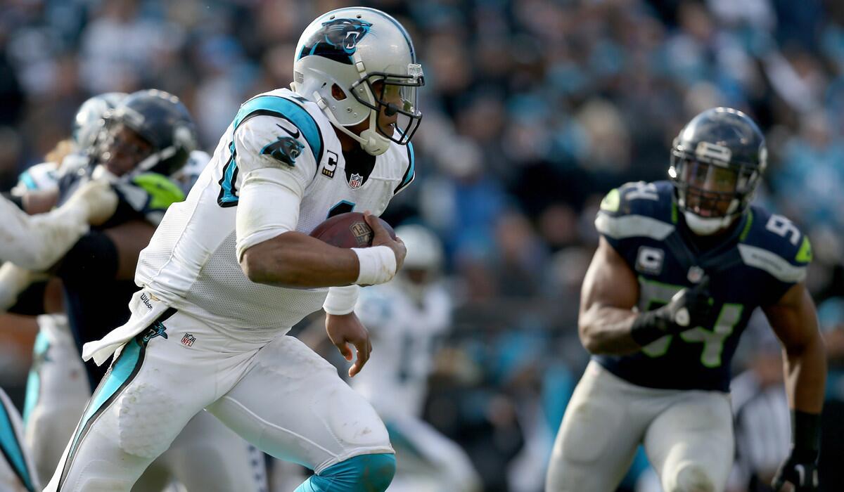 Carolina Panthers quarterback Cam Newton runs the ball against the Seattle Seahawks in the fourth quarter of the NFC Divisional Playoff Game on Sunday.
