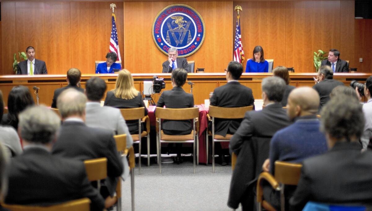 FCC Chairman Tom Wheeler, center, is flanked by Commissioners Ajit Pai, left, Mignon Clyburn, Jessica Rosenworcel and Michael O'Rielly during a hearing and vote on proposed net neutrality rules in Washington.