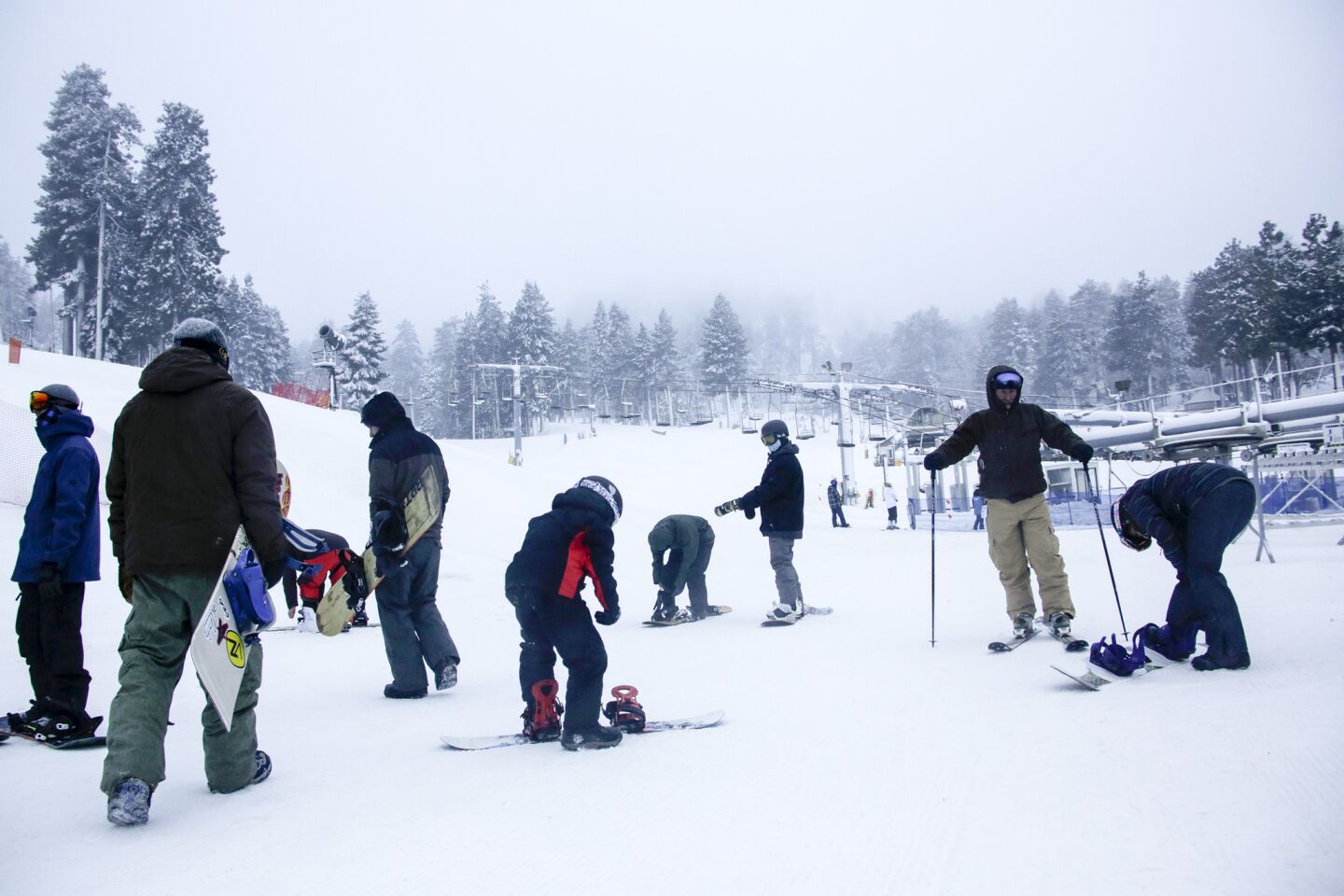 Snow boarders and skiers take advantage of fresh snow as they wait for Mountain High West to open on Wednesday morning.