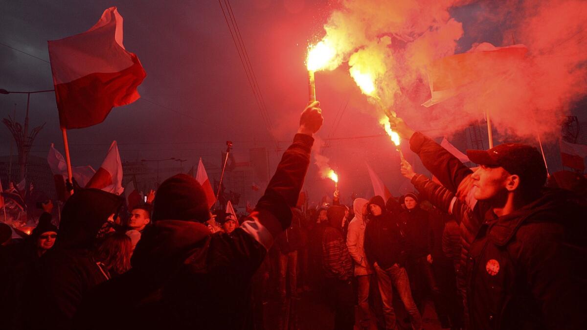 In November 2017, demonstrators burn flares and wave Polish flags during the annual march to commemorate Poland's National Independence Day in Warsaw. Thousands of nationalists took part in an event that was organized by far-right groups last year.