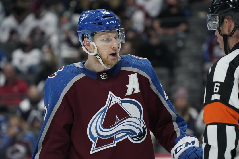 Colorado Avalanche center Nathan MacKinnon, left, argues for a call with referee Francis Charron in the second period of Game 1 of an NHL hockey Stanley Cup first-round playoff series against the St. Louis Blues, Monday, May 17, 2021, in Denver. (AP Photo/David Zalubowski)