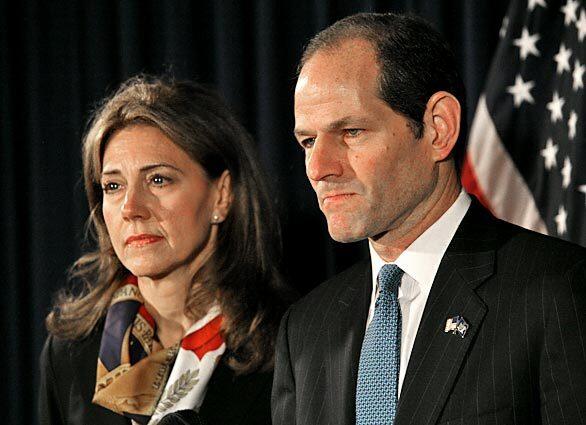 With wife Silda Wall Spitzer at his side, New York Gov. Eliot Spitzer announces his resignation from office after revelations that he had been a client of a prostitution ring.