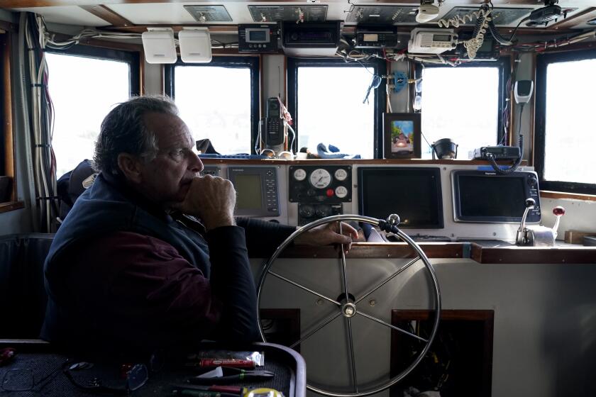 FILE - Bob Maharry sits inside his fishing boat docked at Pier 45 in San Francisco, March 20, 2023. A federal regulatory group has voted to officially close king salmon fishing season along much of the West Coast after near-record low numbers of the fish, also known as Chinook, returned to California's rivers in 2022. (AP Photo/Godofredo A. Vásquez, File)