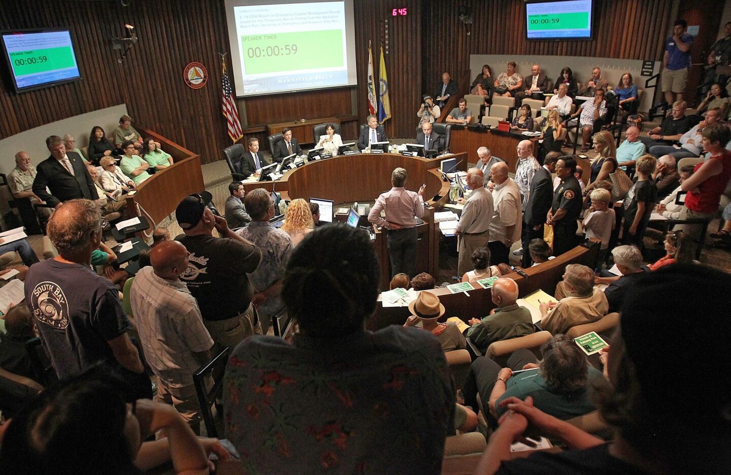 Manhattan Beach residents pack a City Council meeting Tuesday to comment on a proposed permanent fishing ban at the city's pier.