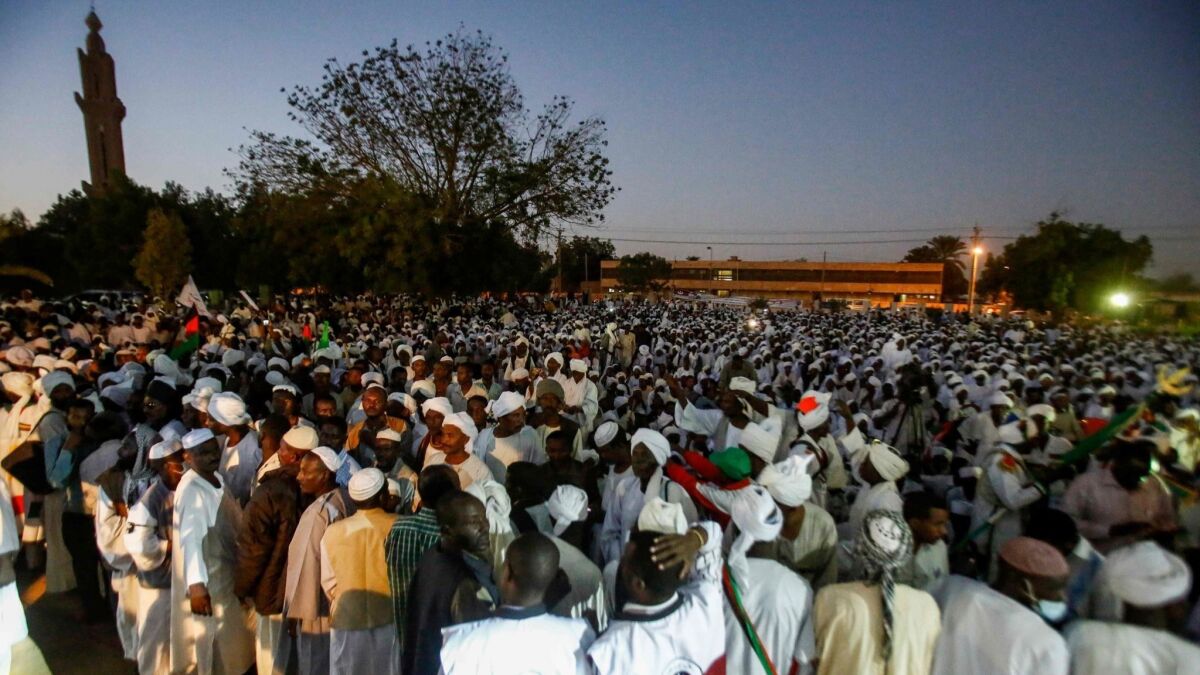 Supporters of Sadek Mahdi, Sudan's ex-prime minister and opposition leader, gather as he addresses them in a mosque in Omdurman on Dec. 19 after his return from exile.