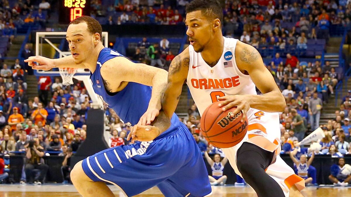 Syracuse's Michael Gbinije drives past Middle Tennessee's Reggie Upshaw during the second half Sunday.