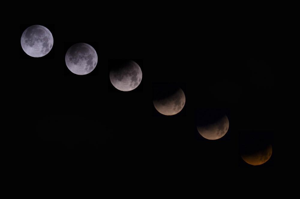A combination of 6 pictures shows the moon in different stages of a total lunar eclipse from the Spanish Canary island of Tenerife on April 15, 2014.