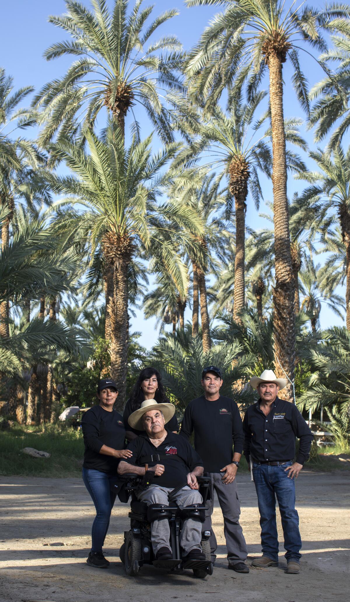 Several family members pose for a photo on a date farm