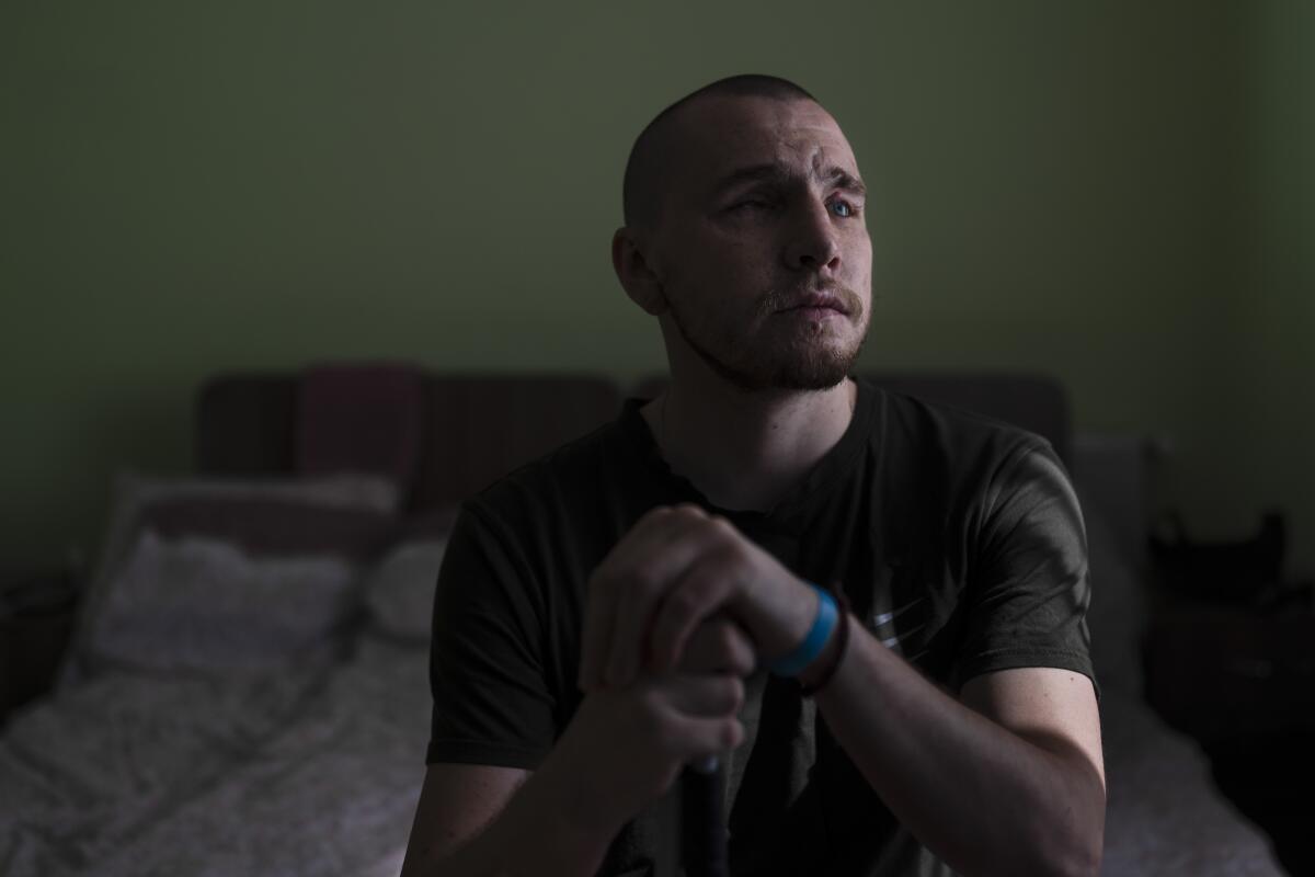 Ivan Soroka, a 27-year-old former Ukrainian soldier blinded in the war, sits for a photo in his room.