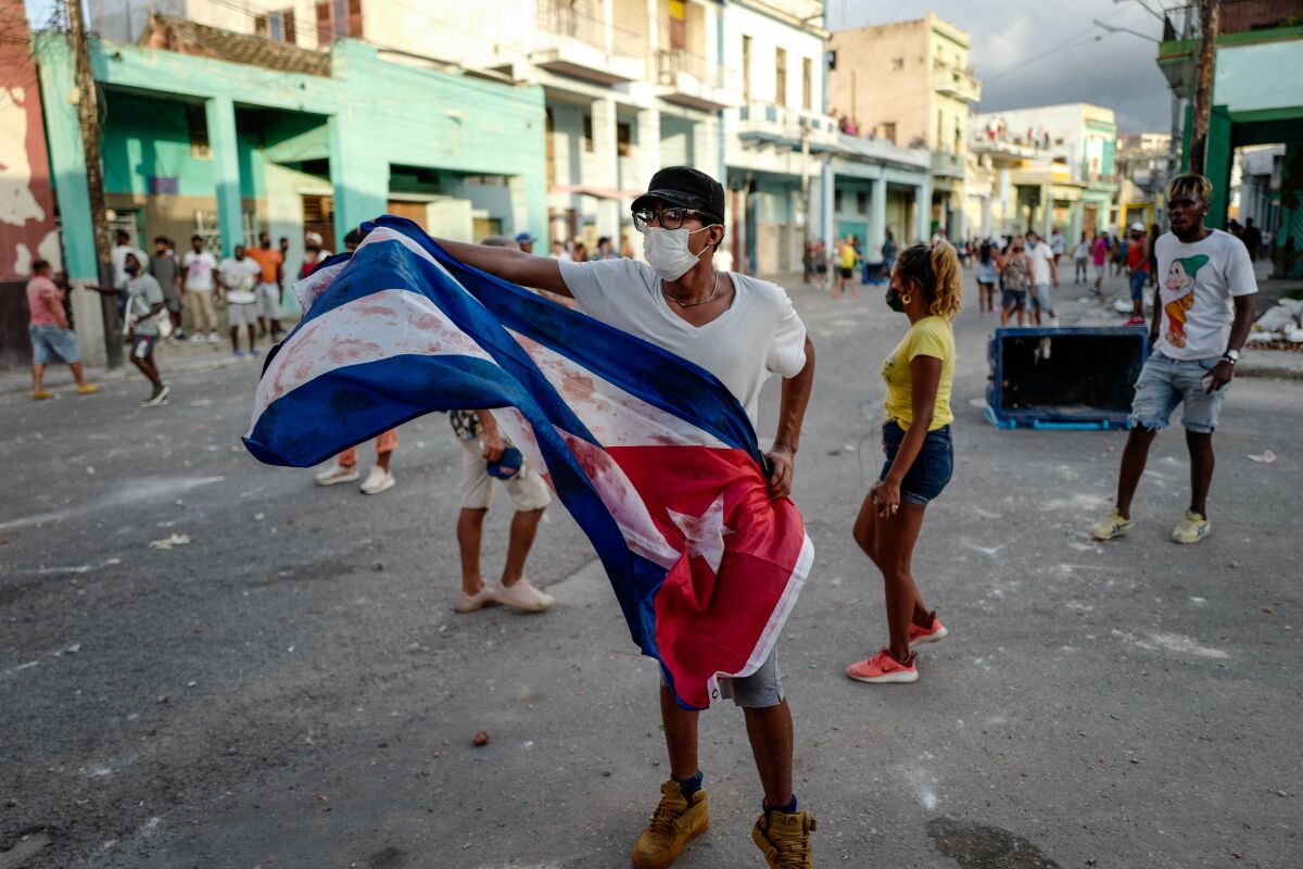 A man waves a Cuban flag at a protest in Havana against the Cuban government on July 11. 