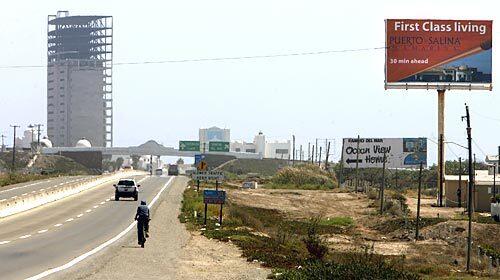 A condo tower rises above the highway into Rosarito, Mexico. About 7,000 condominiums are under construction from Tijuana to Ensenada, with 5,600 others in the planning stages. But the area's real estate market is flagging because of the U.S. sub-prime mortgage debacle and the credit squeeze.