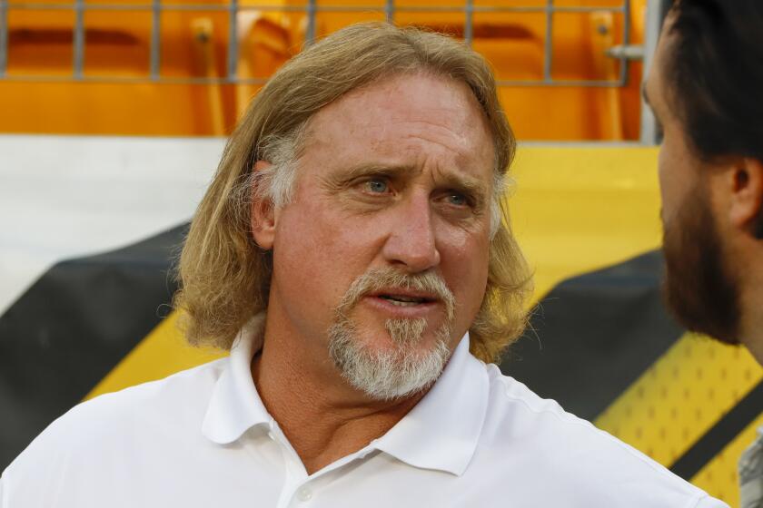 Pro Football Hall of Fame outside linebacker Kevin Greene stands on the sidelines during warmups.