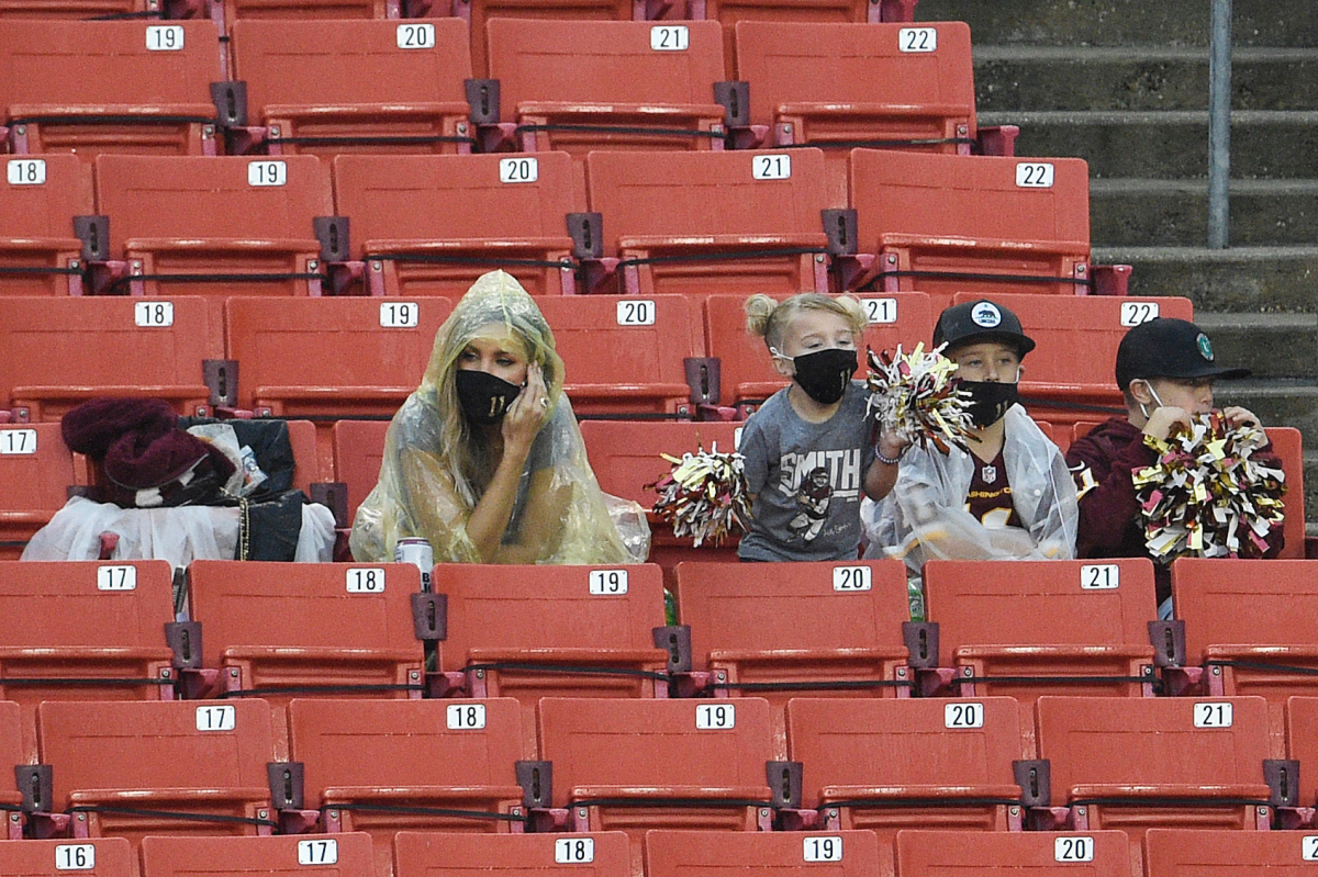 Alex Smith's wife, Elizabeth Smith sits next to the couple's children during Sunday's game.