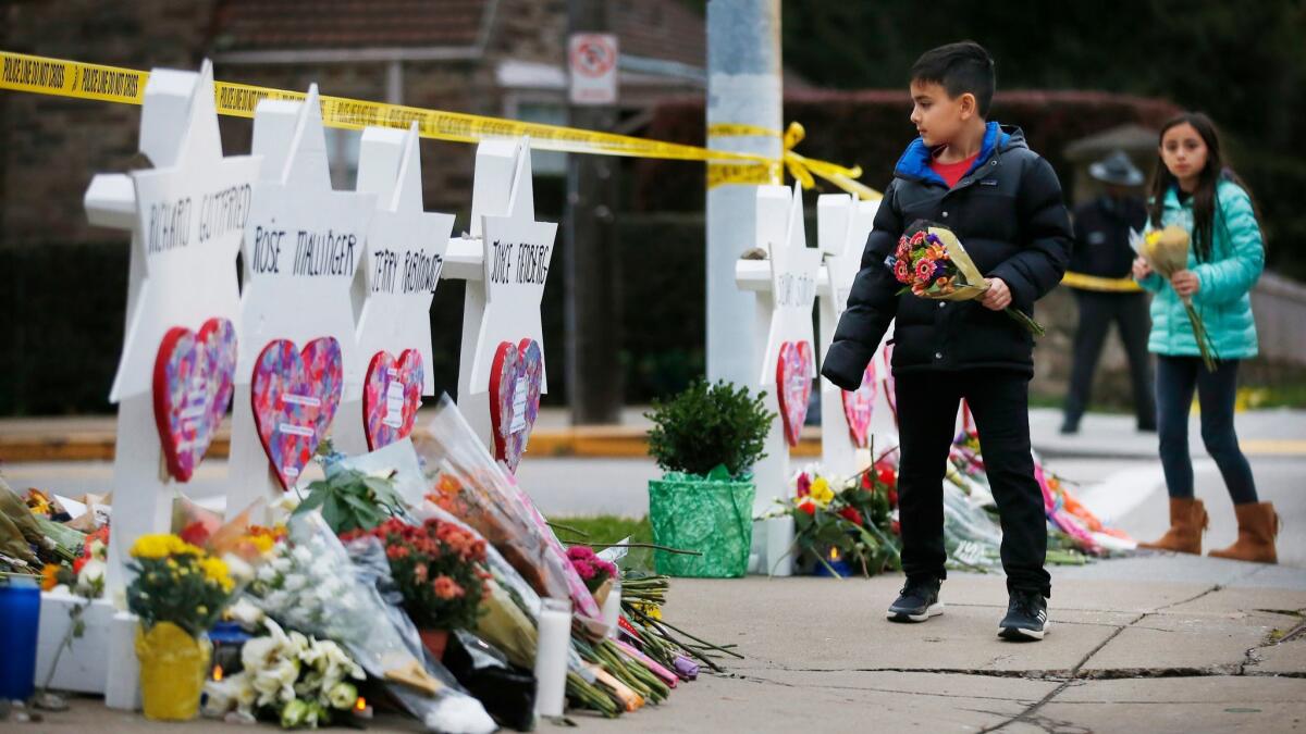 Children leave flowers in front of Star of David memorials at the Tree of Life Synagogue two days after a mass shooting in Pittsburgh.