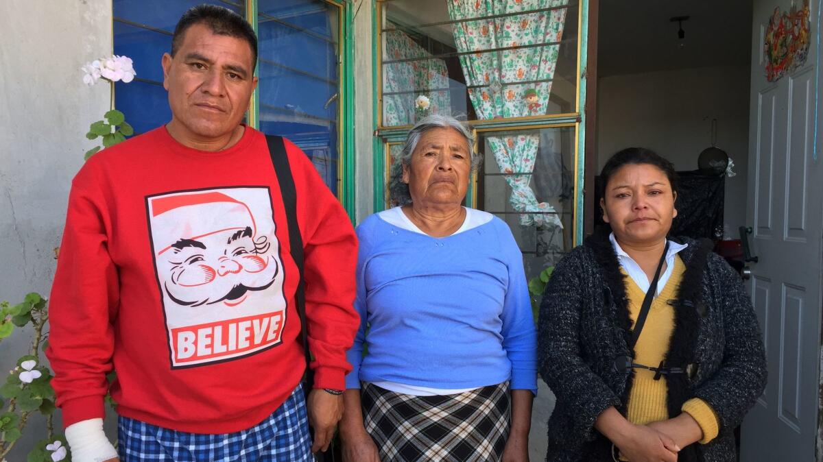 Juan Martinez Leon with his mother, Lorenza Leon Lopez, and sister, Marie Cruz Aguilar Mendoza, who all survived the explosion, at their home in Tultepec's San Antonio Xahuento neighborhood.