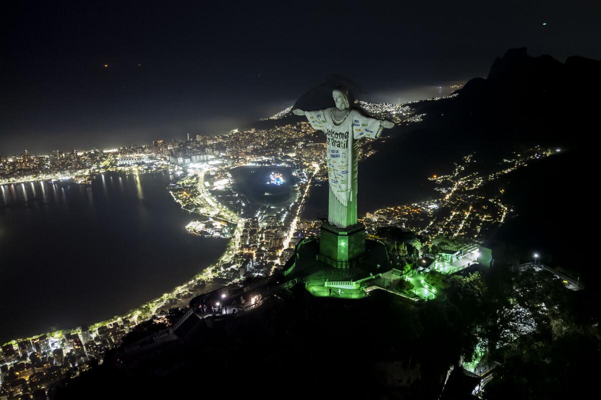 The Christ the Redeemer statue is illuminated with a welcome message for Taylor Swift