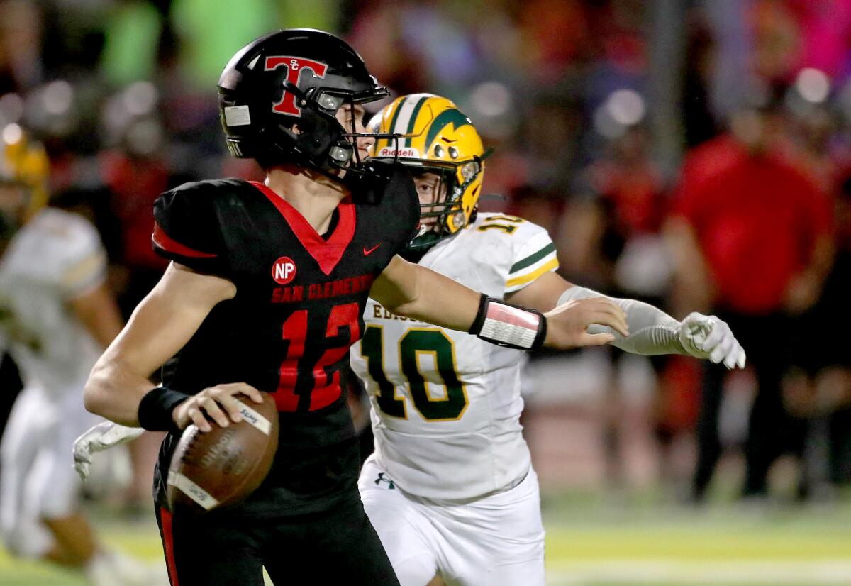 Edison defender Jake Giles pressures San Clemente quarterback Broderick Redden during Friday night's game.