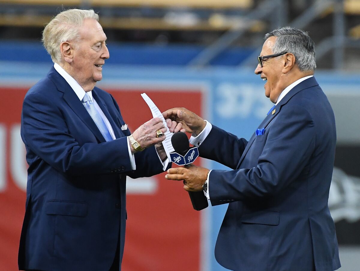 Retired Dodgers broadcaster Vin Scully, left, jokes with Dodgers Spanish-language broadcaster Jaime Jarrin