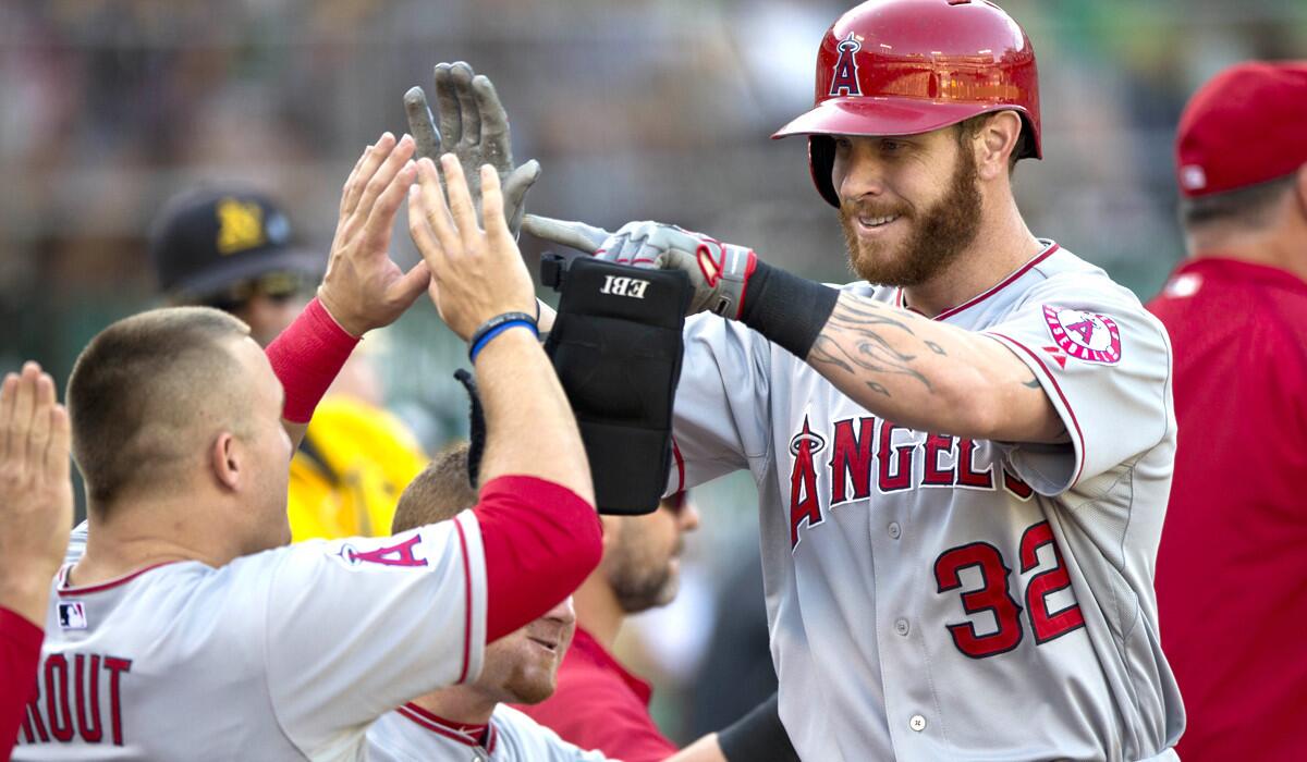 Angels outfielder Josh Hamilton is congratulated by teammate Mike Trout after hitting a two-run home run against the A's last month in Oakland.
